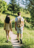 rear-view-couple-hiking-together-outdoors